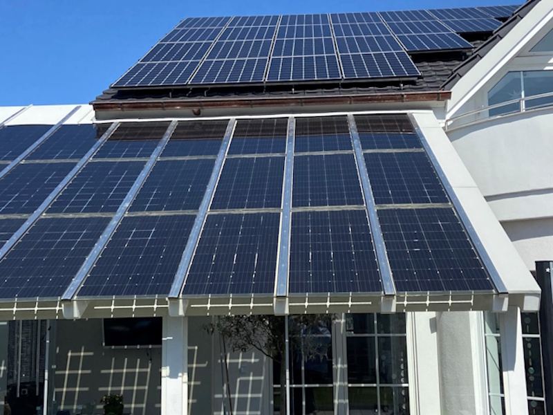 Private residence in Hassloch, Germany, with solar panels on the roof and a glass canopy